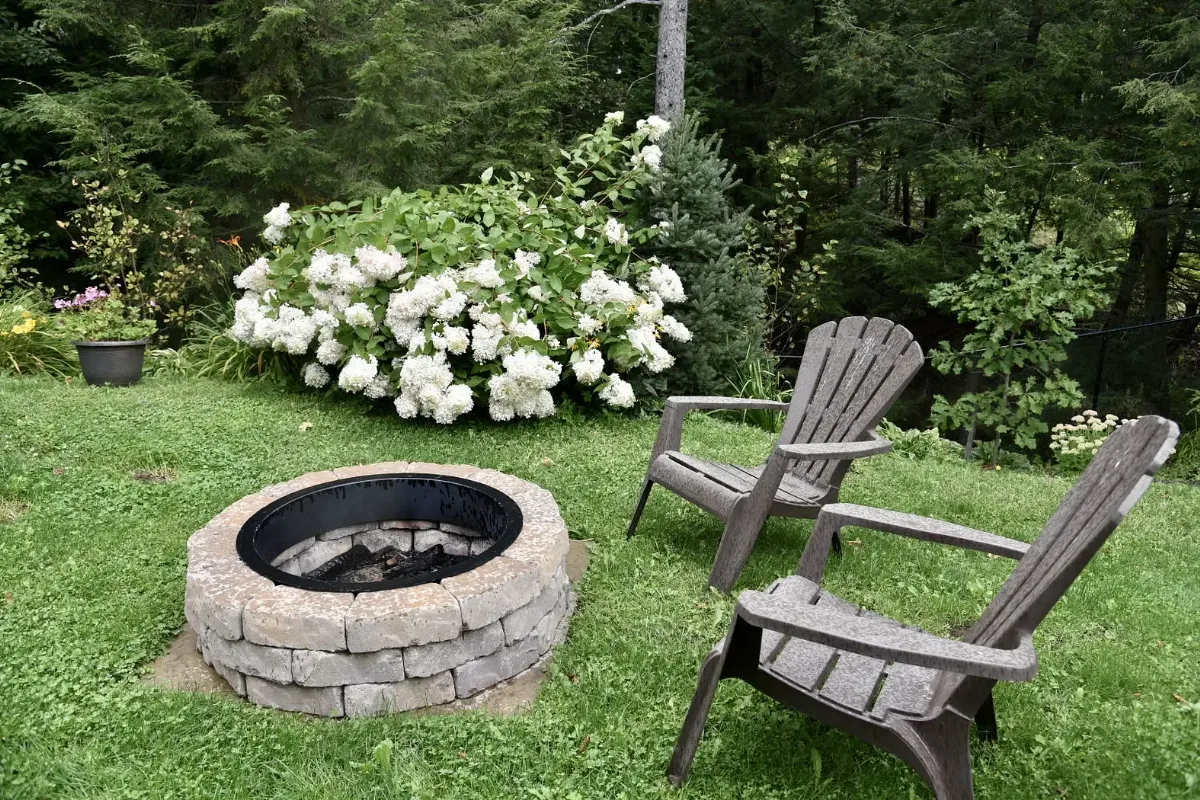 An outdoor seating area beside a flowering garden